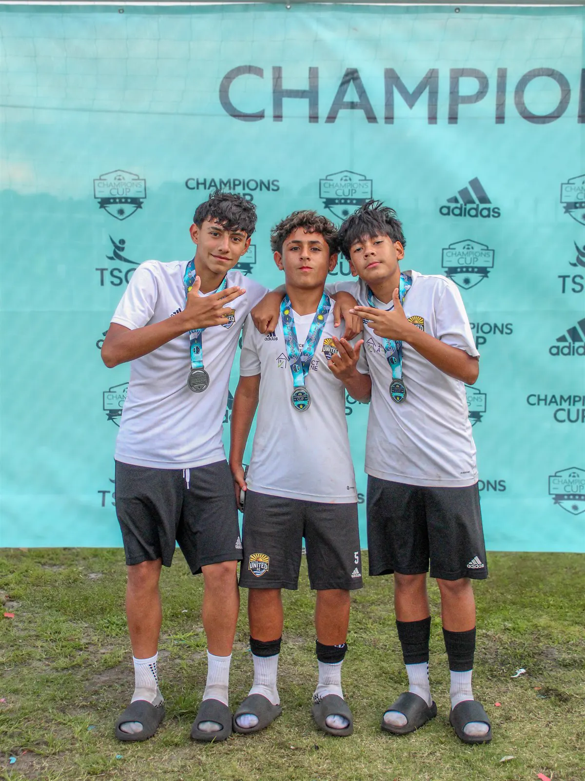 CFU FC players wearing Champions Cup medals